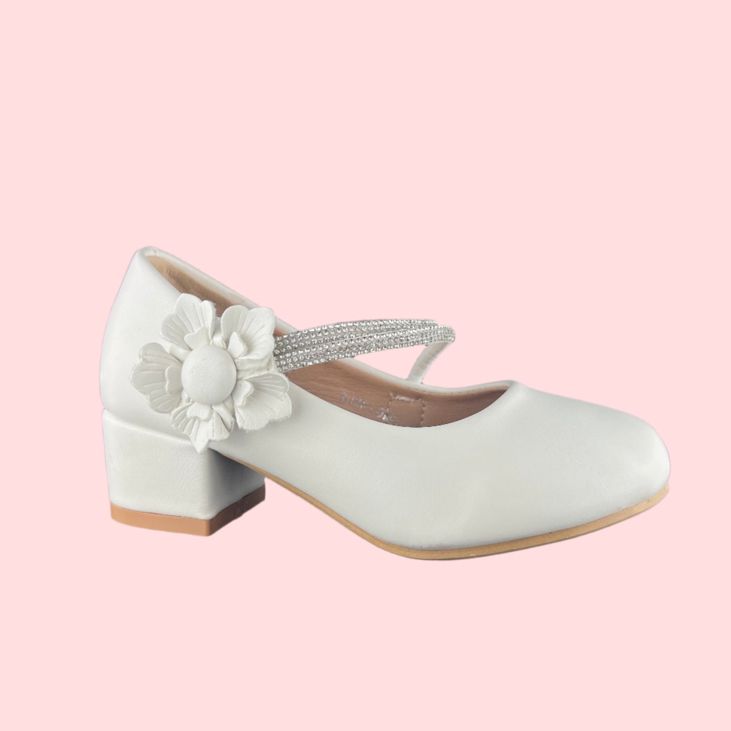 White shoe with floral design on a dark surface