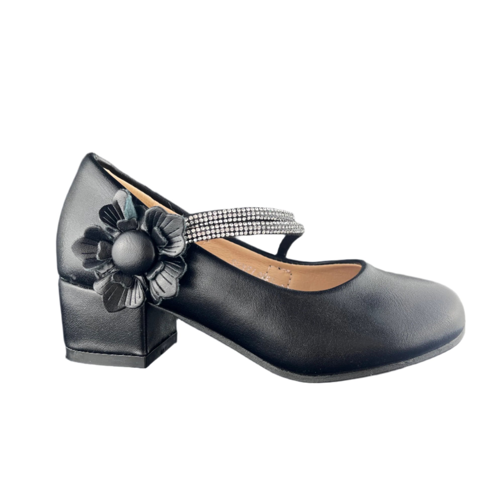 Black shoe with a decorative flower and strap on a dark surface