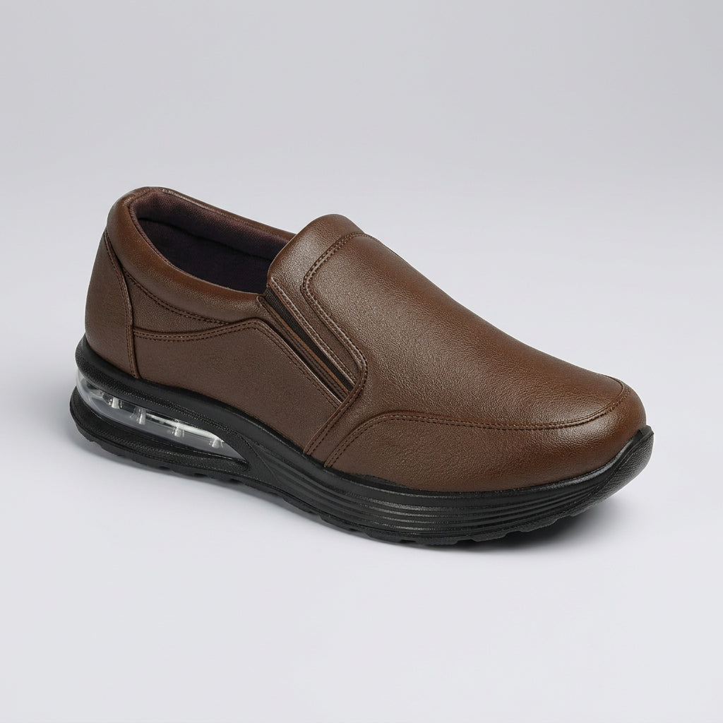 A brown slip-on shoe with a textured leather-like upper, elastic side panel, and a black sole featuring a visible clear air cushion unit, shown on a plain white background.